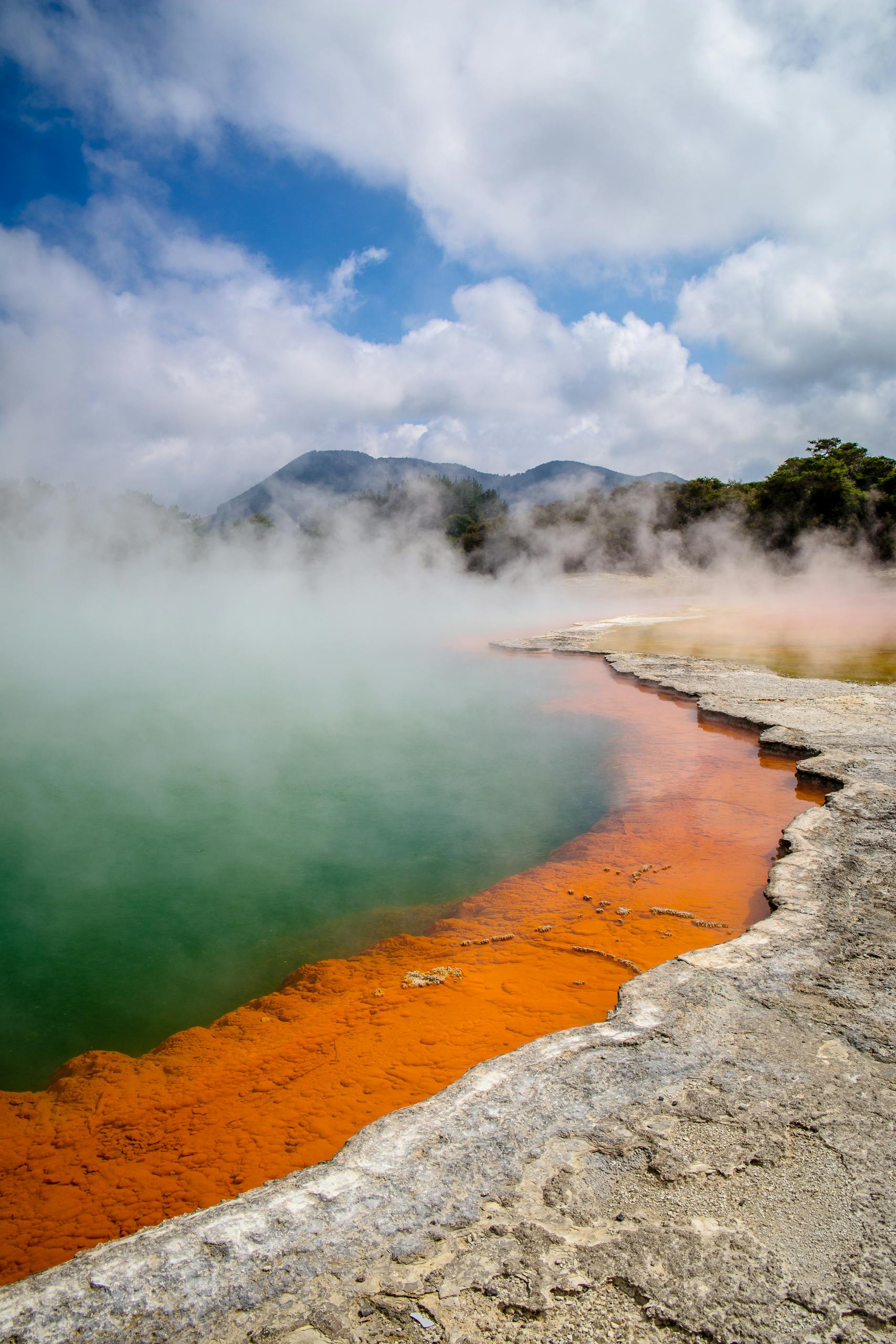 Countries 7 Stunning geothermal Champagne Pool with vivid colors and steam at Wai-O-Tapu, New Zealand.